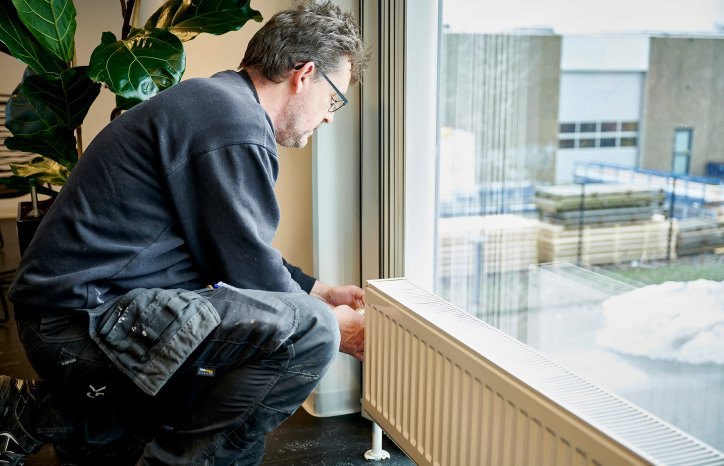 Billede af en medarbejder, der yder service på en radiator 